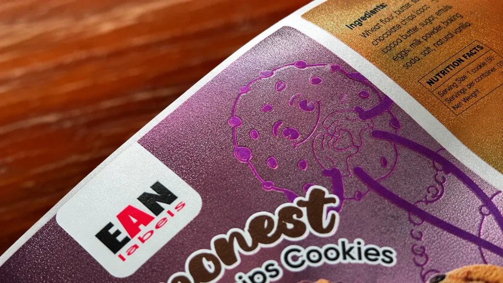 Close-up of Sand Blasting sticker finishing showing a fine frosted surface texture on a printed label.