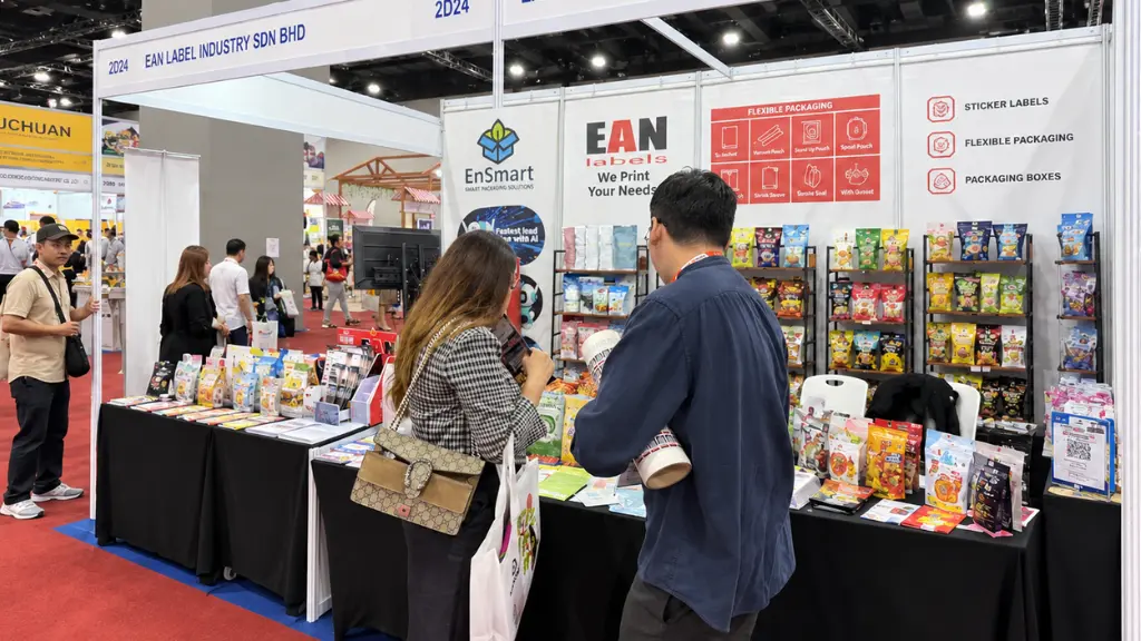 Visitors exploring EAN Label’s sticker labels, flexible packaging and packaging box samples at the MIHAS 2026 exhibition booth